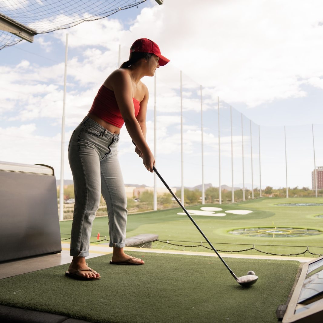 woman playing golf during daytime