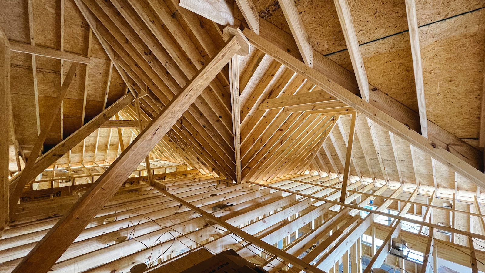 attic insulation with brown wooden ceiling